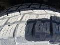 Close-up of a truck tire tread showcasing deep grooves and patterns on a 2014 Ford F-150 tire