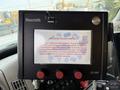 A control panel with a touchscreen display and three red buttons labeled warning glass parts
