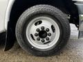 Close-up of a 2017 Chevrolet Express wheel featuring a silver rim with multiple lug nut holes and a black tire with the brand name visible