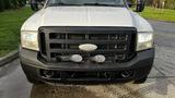 A 2007 Ford F-550 with a black grille and two round lights mounted on the front bumper