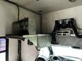 Interior view of a 2006 GMC C5000 featuring a metal shelf with equipment and ventilation system above the driver's seat