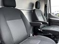 Two front seats of a 2020 Ford Transit with fabric upholstery and armrests