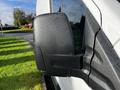 A close-up of the side mirror on a 2020 Ford Transit with water droplets on its surface