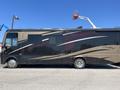 2008 Newmar Canyon Star 36 Foot Class A Motorhome with a black and gold exterior featuring curved red stripes on the side