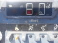 Control panel of a 2008 JLG Boom Lift featuring various switches and indicators for operation settings