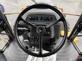 Interior view of a 2011 John Deere 310SJ 4x4 Wheel Loader showing the steering wheel and control panel