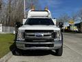 Front view of a 2018 Ford F-550 with a white exterior and yellow emergency lights on top
