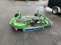 A green 2014 John Deere 1585 Terrain Cut mower with a flat cutting deck, grass discharge chute, and multiple wheels resting on a wooden pallet