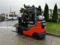 A red and gray 2017 Toyota 8FCGCU25 forklift with an industrial design and a propane tank on the back