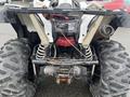 A 2017 Polaris Scrambler with a distinct rear view showing large tires a rear suspension system and a mounted exhaust pipe