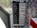 A 2006 Emergency One Fire Truck featuring a metal plaque detailing vehicle specifications fluid types and capacities