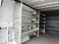 Interior of a 2017 Mercedes-Benz Sprinter van with metal shelving units installed on one side for storage and organization