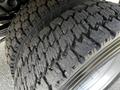 Close-up of a tire tread from a 2016 Ford F-550 showing deep grooves and wear patterns indicating usage on rugged terrain