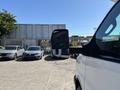 A white 2017 Chevrolet Express cargo van with a large side mirror is parked in a lot, positioned at an angle to showcase the mirror and front profile