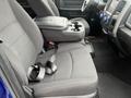 Interior of a 2019 RAM 1500 Classic showing two front seats with a center console and cup holders