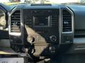 Interior dashboard of a 2017 Ford F-150 featuring a central touchscreen display and climate control knobs