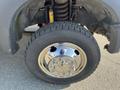 The tire of a 2015 Ford F-450 SD with a chrome wheel rim and visible treads