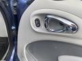 A close-up of the door lock switch and handle of a 2007 Chrysler PT Cruiser featuring a chrome trim and a grey interior panel