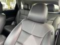 Interior of a 2015 Kia Sorento featuring black leather front seats with visible stitching and headrests