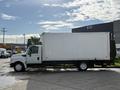 A 2014 International TerraStar truck with a large white box cargo area parked at an angle on a paved surface