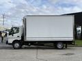 A side view of a 2014 Hino 195 box truck featuring a white cargo area and a visible cab with black details