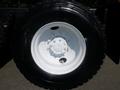 A close-up view of a black tire mounted on a white wheel from a 2009 International 7400 truck