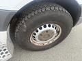 Close-up of a wheel and tire of a 2009 Dodge Sprinter Van showing a distinctive aluminum wheel design and rugged tread pattern