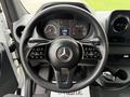Steering wheel of a 2019 Mercedes-Benz Sprinter with control buttons and dashboard visible in the background