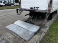 A 2018 Isuzu NRR with a metallic loading ramp extended at the rear
