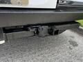 A close-up view of the rear hitch receiver on a 2012 Mercedes-Benz Sprinter showing a damaged and wet surface