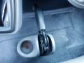 A close-up view of the gear shift lever in a 2014 International Durastar with a silver finish and a textured grip