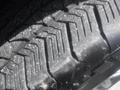 Close-up of a tire tread from a 2022 Ford F-150 showing detailed patterns and grooves designed for traction