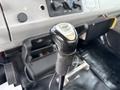Close-up of a gear shift lever labeled Eaton Fuller in the cabin of a 1998 Freightliner FL80