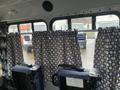 2012 Chevrolet Express with blue fabric seats and patterned curtains in view from inside the vehicle