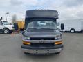 A 2016 Chevrolet Express van with a black exterior and a boxy front design featuring a visible Chevrolet emblem and large windshield