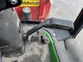 Close-up of the control lever and foot pedals inside a 2014 John Deere 1585 Terrain Cut mower