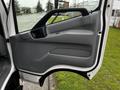 A gray interior door panel of a 2018 Hino 195 truck featuring a handle and a smooth surface