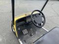 Interior view of a 2000 Ez-go Industrial 800 showing the steering wheel and foot pedals