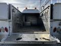 A 2018 Ford F-550 truck with an open cargo area showing a metal interior and various hooks along the side walls