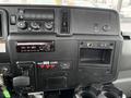Dashboard of a 2020 International MV607 featuring various control buttons a radio display and a cup holder