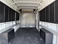 Interior of a 2017 RAM Promaster van showing a spacious cargo area with black side panels and two large black storage boxes on the floor