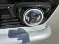 Close-up of a vintage 1962 Ford F-100 headlight featuring a circular design with dual lenses and a chrome trim