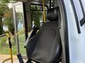 A black seat inside a 2020 Chevrolet Express van with a safety belt visible next to it