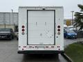 White 2012 Ford Econoline van with a closed rear door and small access hatch visible