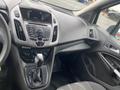 Interior view of a 2017 Ford Transit Connect showing the dashboard gear shift controls and audio system display