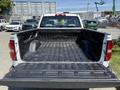 View of the open bed of a 2016 GMC Sierra 1500 featuring a textured lining and the GMC logo visible on the truck's side walls