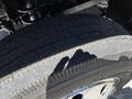 Close-up of a tire on a 2015 RAM 5500 showing detailed tread pattern and some wear with a shadow of a hand visible on the surface