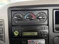 Dashboard controls of a 2011 International 4300 featuring climate dials and a radio display showing the time as 7:35