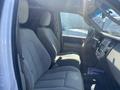 Interior view of a 2013 Ford Expedition showing two front seats and dashboard with controls and a display