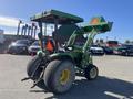 A 2008 John Deere 3320 tractor with a 300X loader attachment featuring large rear tires and a raised loader bucket